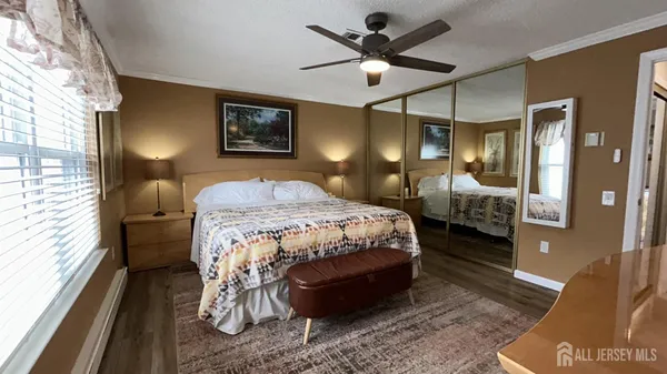 a bedroom with a bed mirror and a window