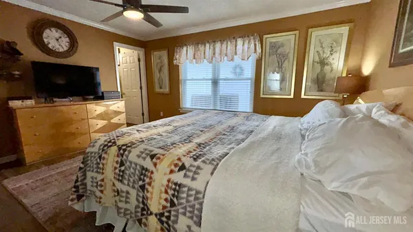 a bed sitting in a spacious bedroom next to a window