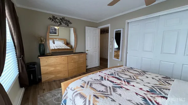 a bedroom with a bed and a dresser in it