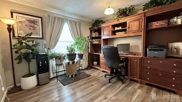a view of a workspace with furniture and a window