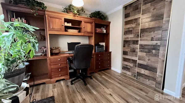 a view of a workspace with furniture and wooden floor