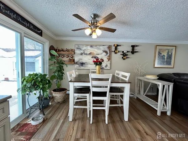 a view of a dining room with furniture wooden floor and chandelier