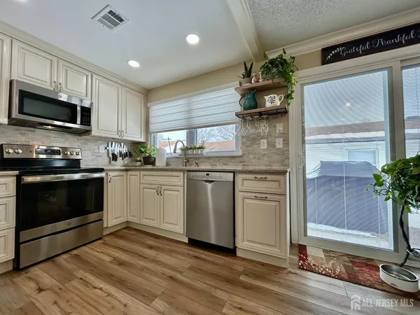a kitchen with a white stove top oven and refrigerator