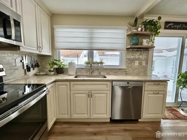 a kitchen with stainless steel appliances granite countertop a sink and stove