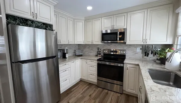 a kitchen with a refrigerator stove and sink