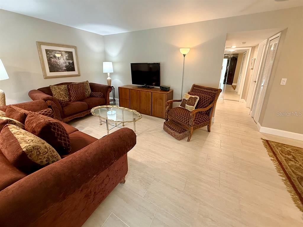 4455 Duhme Road, Unit 103 St. Petersburg, FL 33708 - Photo 11 of 37 a living room with furniture and a flat screen tv