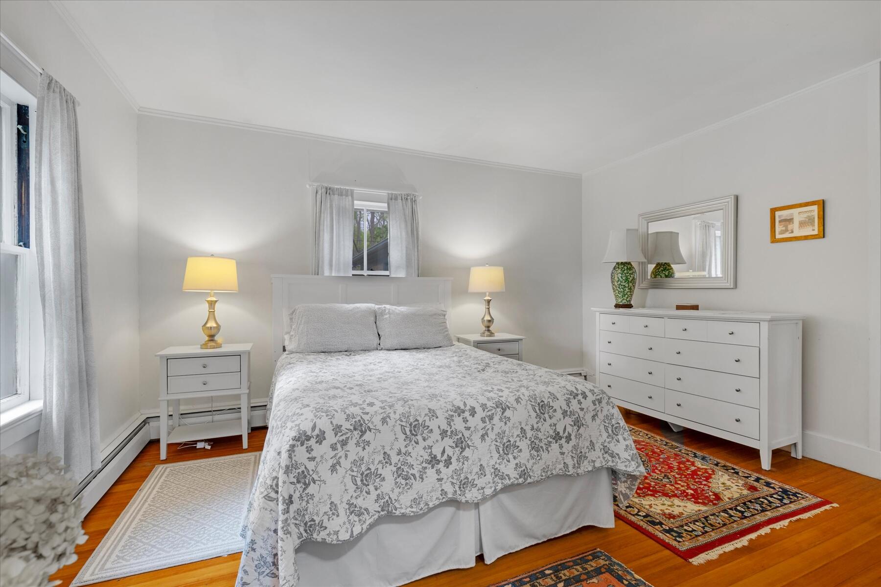 21 Quaker Road East Sandwich, MA 02537 - Photo 19 of 43 a bedroom with a bed and wooden floor