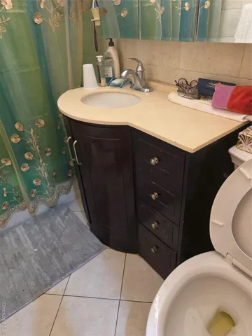 a bathroom with a sink vanity and toilet