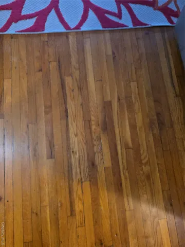 a room with a wooden door and curtain