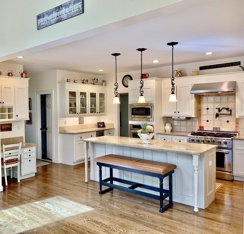 39 Vine Brook Road Medfield, MA 02052 - Photo 12 of 42 a open kitchen with stainless steel appliances granite countertop a stove and a refrigerator