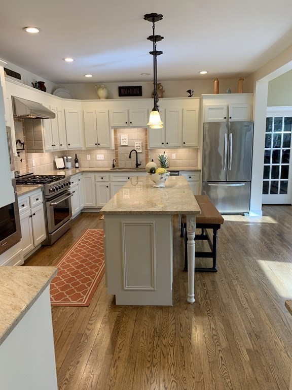 39 Vine Brook Road Medfield, MA 02052 - Photo 14 of 42 a kitchen with stainless steel appliances granite countertop a sink a stove and a wooden floors