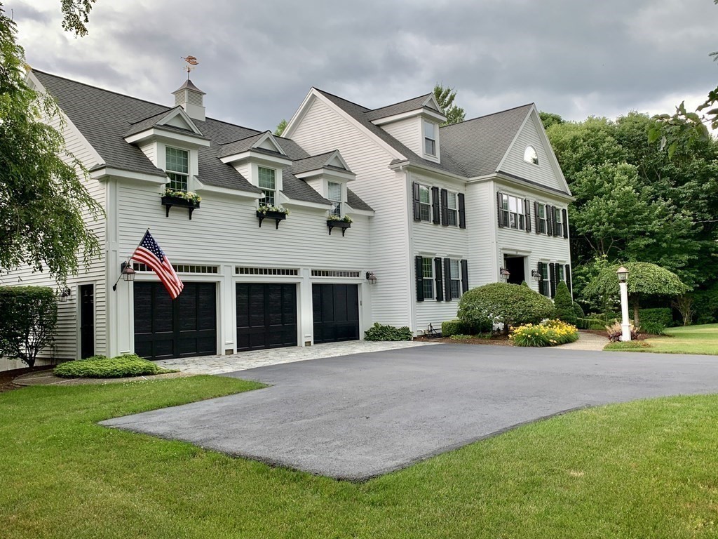 39 Vine Brook Road Medfield, MA 02052 - Photo 2 of 42 a front view of a house with garden
