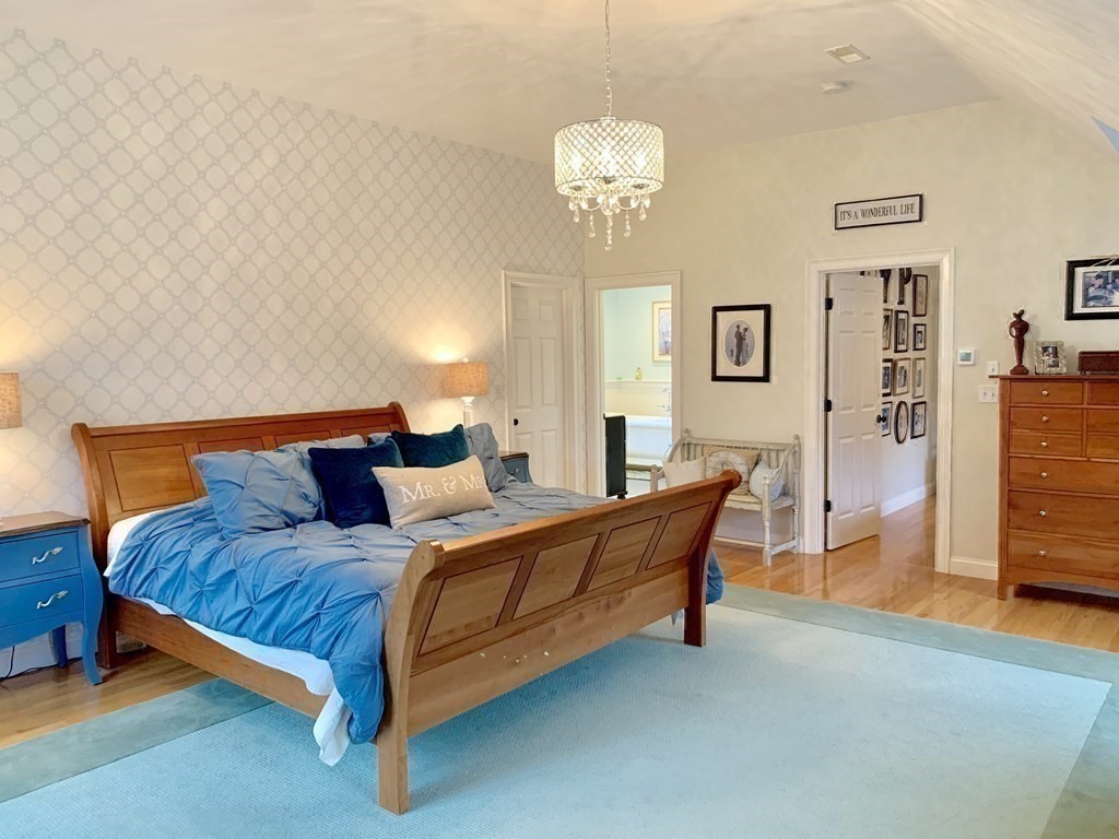 39 Vine Brook Road Medfield, MA 02052 - Photo 26 of 42 a spacious bedroom with a bed and a table in it