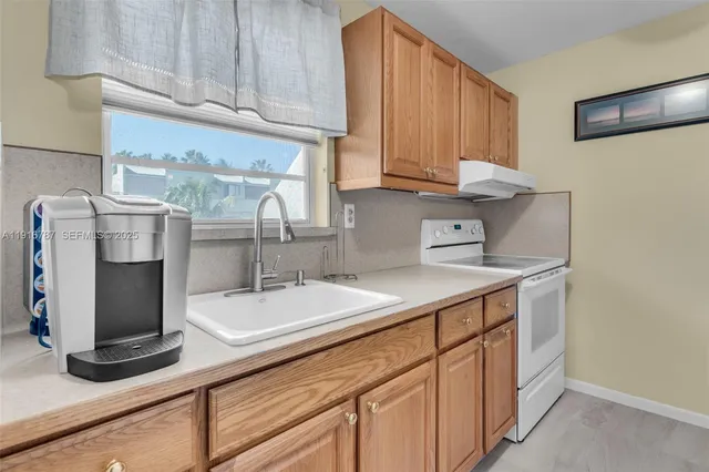 a view of a hallway to a livingroom with furniture