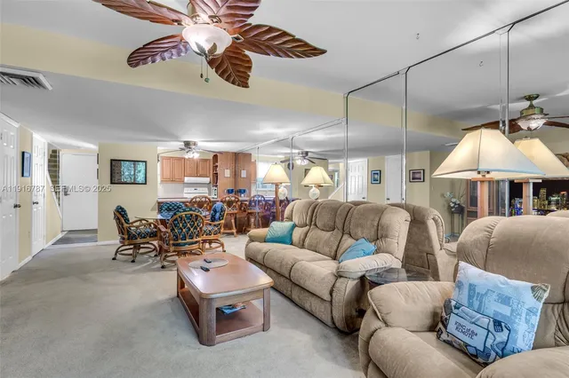 a living room with furniture and a ceiling fan