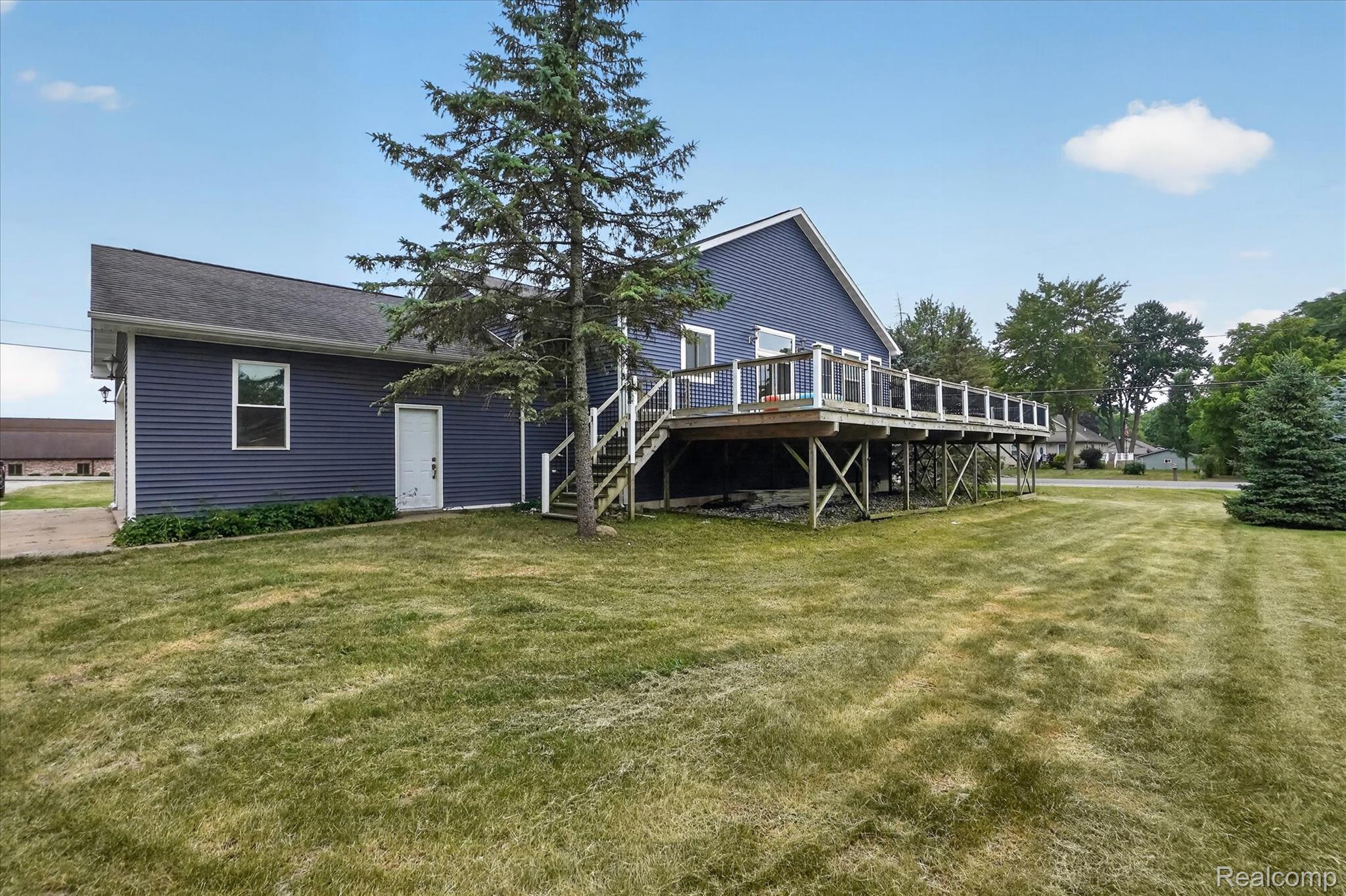 6524 Kelly Road Flushing, MI 48433 - Photo 47 of 47 Expansive outdoor deck with white railings and supporting columns