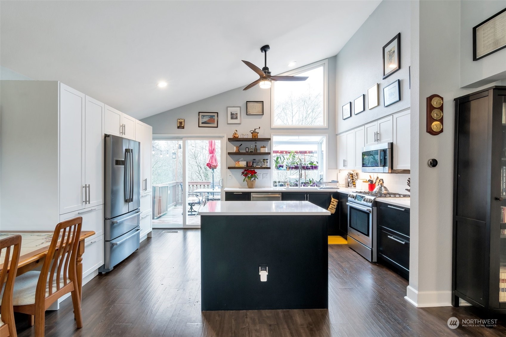 22205 5th Drive Southeast Bothell, WA 98021 - Photo 3 of 15 a kitchen with stainless steel appliances granite countertop a refrigerator a stove top oven a sink dishwasher and white cabinets with wooden floor