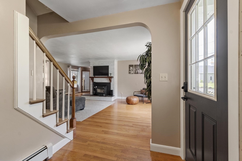 167 Gates Pond Road Berlin, MA 01503 - Photo 9 of 32 a view of a hallway to a livingroom with wooden floor and windows