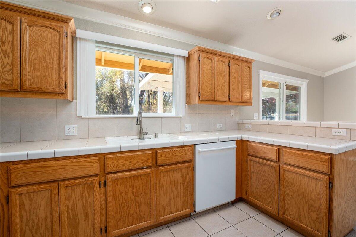 7704 Pit Road Redding, CA 96001 - Photo 12 of 34 a kitchen with sink cabinets and window