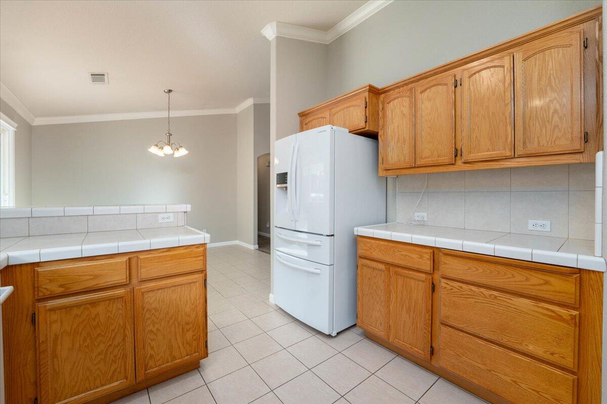 7704 Pit Road Redding, CA 96001 - Photo 13 of 34 a white refrigerator freezer sitting inside of a kitchen