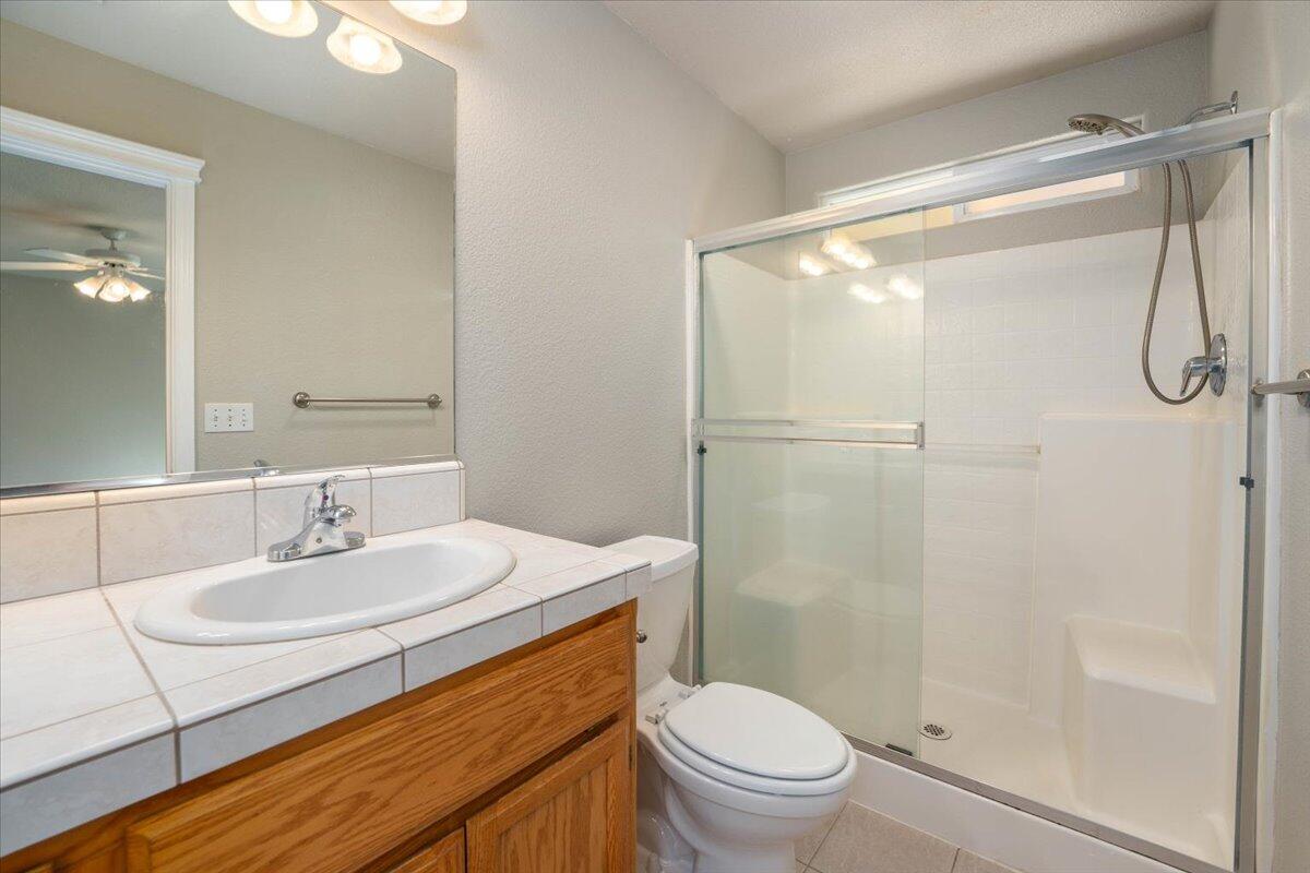7704 Pit Road Redding, CA 96001 - Photo 16 of 34 a bathroom with a sink toilet and shower