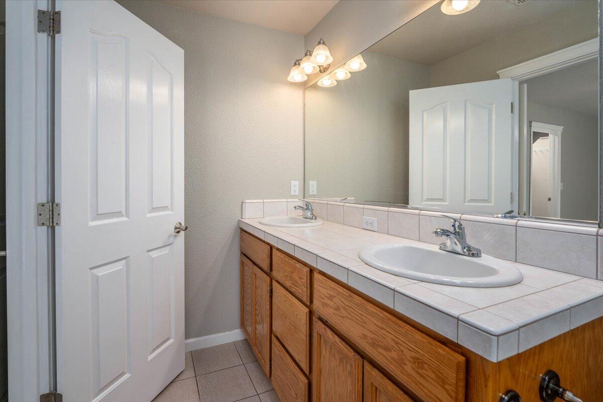 7704 Pit Road Redding, CA 96001 - Photo 17 of 34 a bathroom with a sink and a mirror