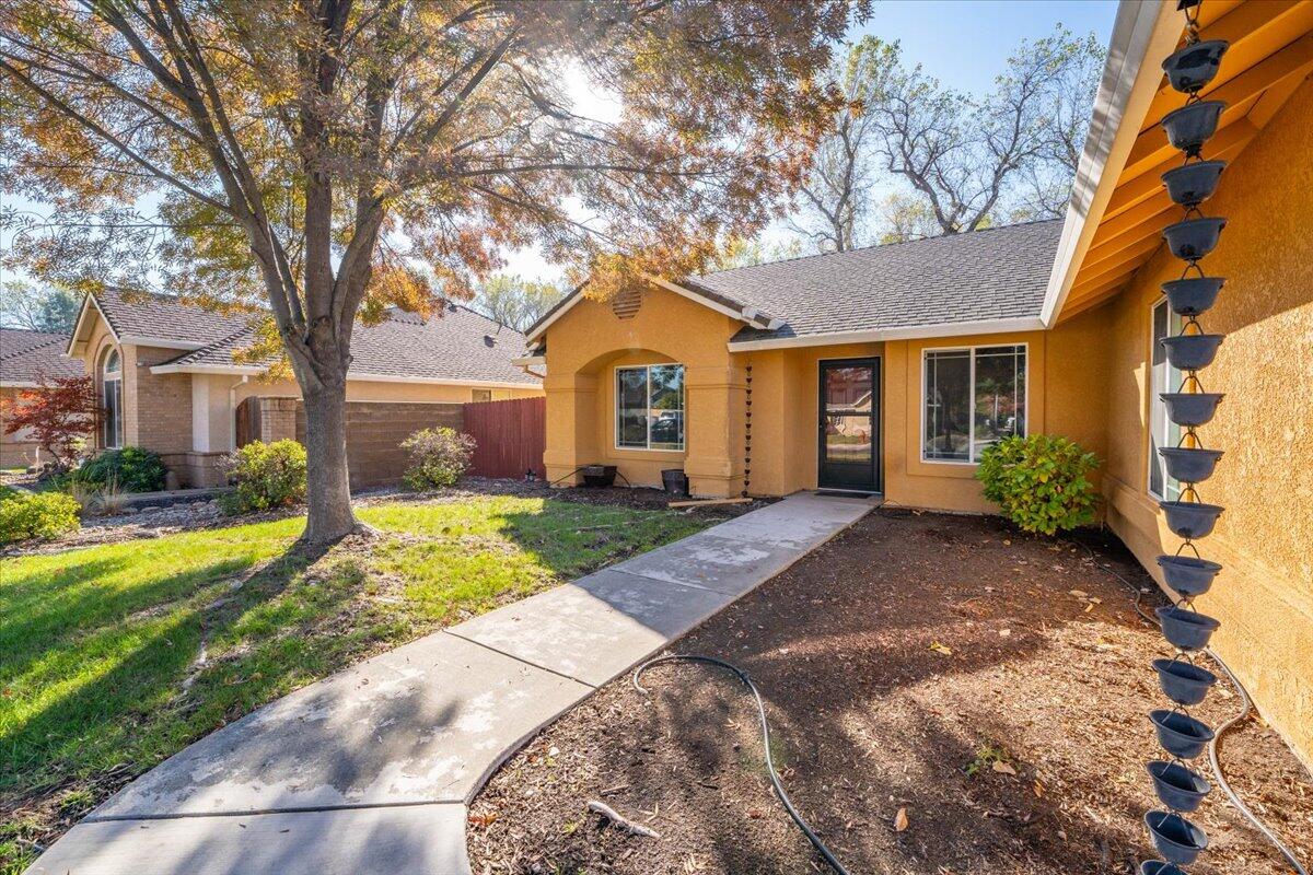7704 Pit Road Redding, CA 96001 - Photo 5 of 34 a front view of a house with a yard and trees