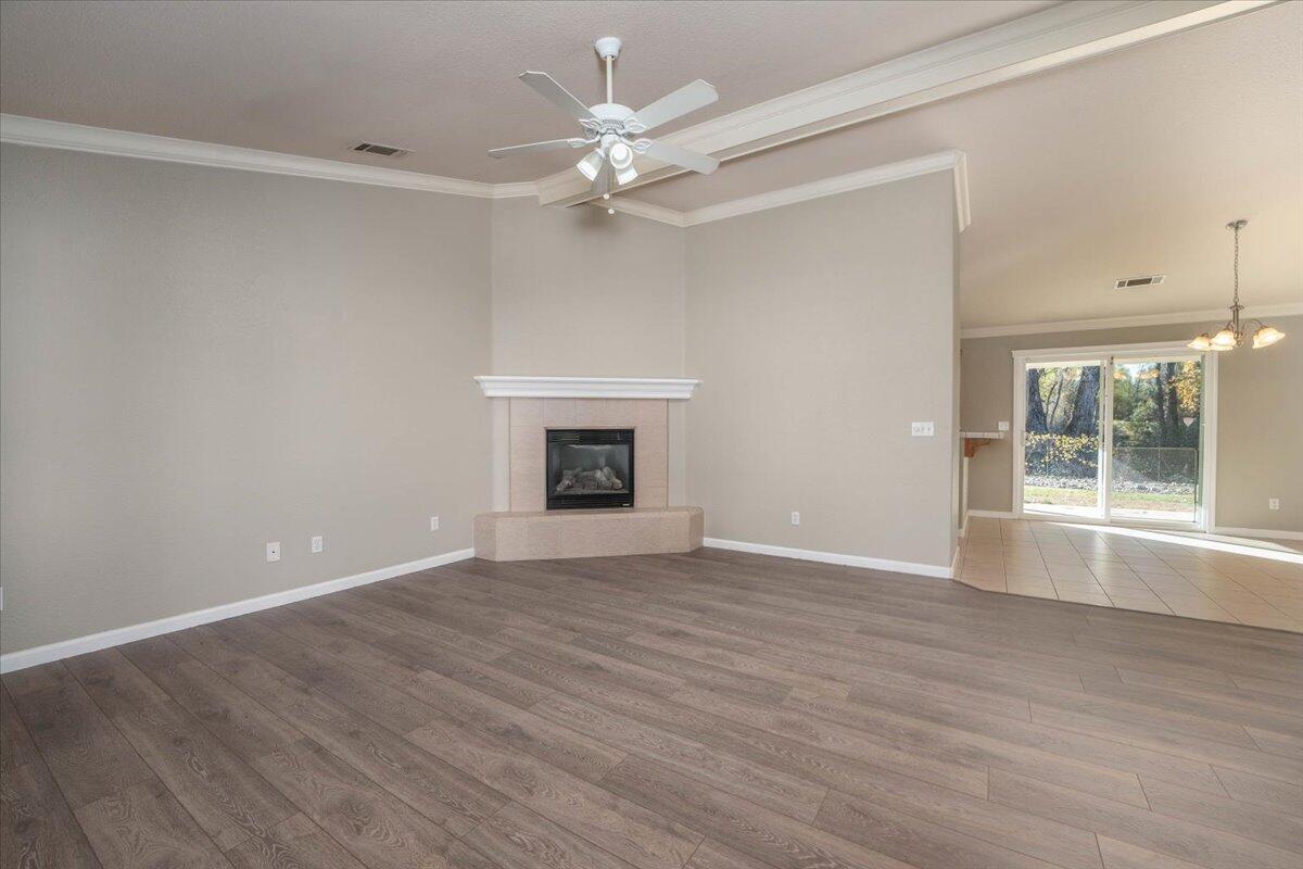 7704 Pit Road Redding, CA 96001 - Photo 9 of 34 a view of an empty room with window and wooden floor