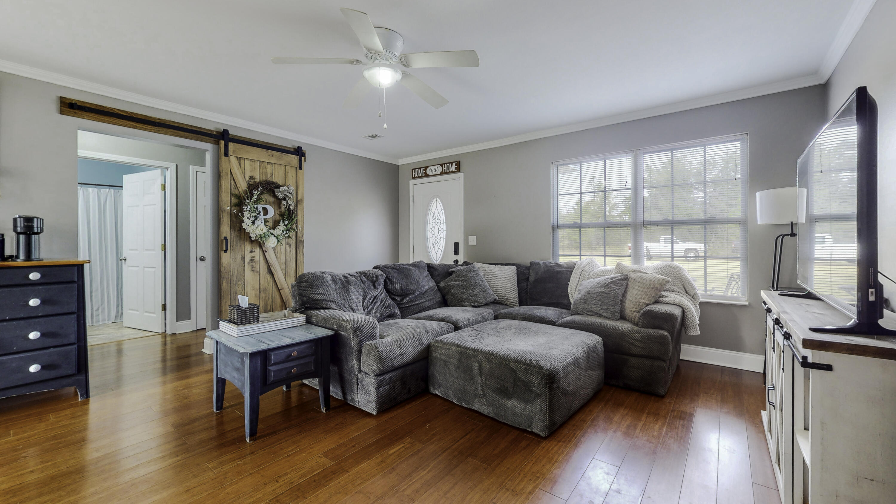 4696 Bobolink Way Crestview, FL 32539 - Photo 11 of 21 a living room with furniture a ceiling fan and a flat screen tv