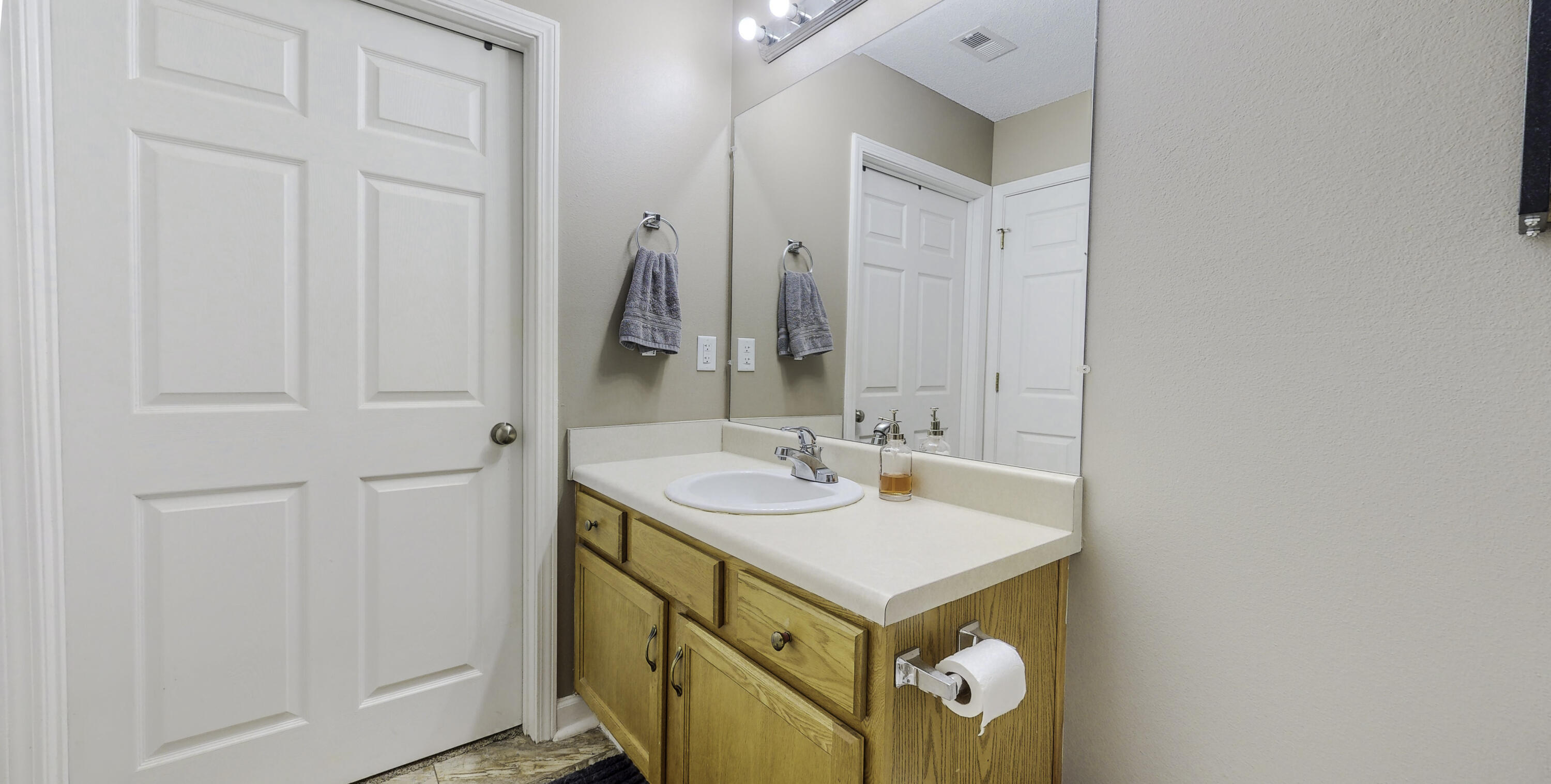 4696 Bobolink Way Crestview, FL 32539 - Photo 15 of 21 a bathroom with a sink a vanity and a mirror