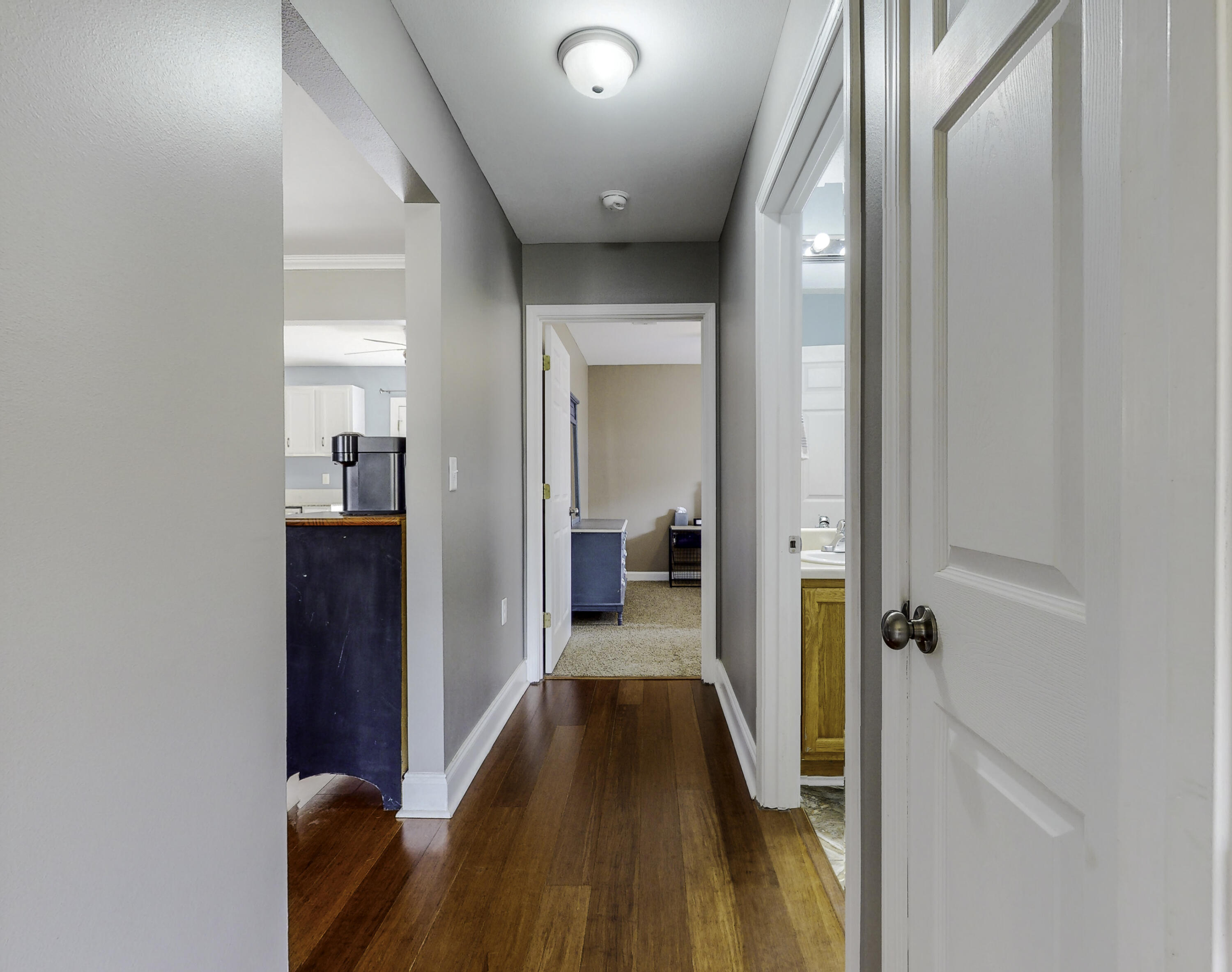 4696 Bobolink Way Crestview, FL 32539 - Photo 16 of 21 a view of a hallway with wooden floor and staircase