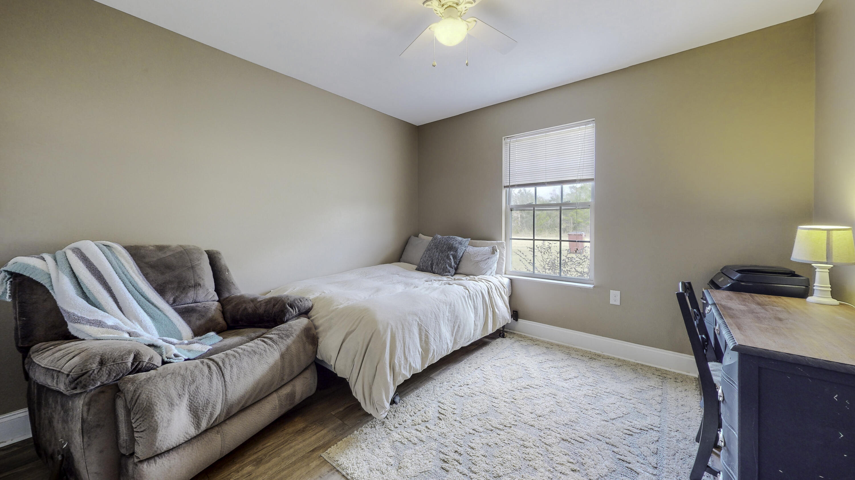 4696 Bobolink Way Crestview, FL 32539 - Photo 18 of 21 a bedroom with a bed and wooden floor