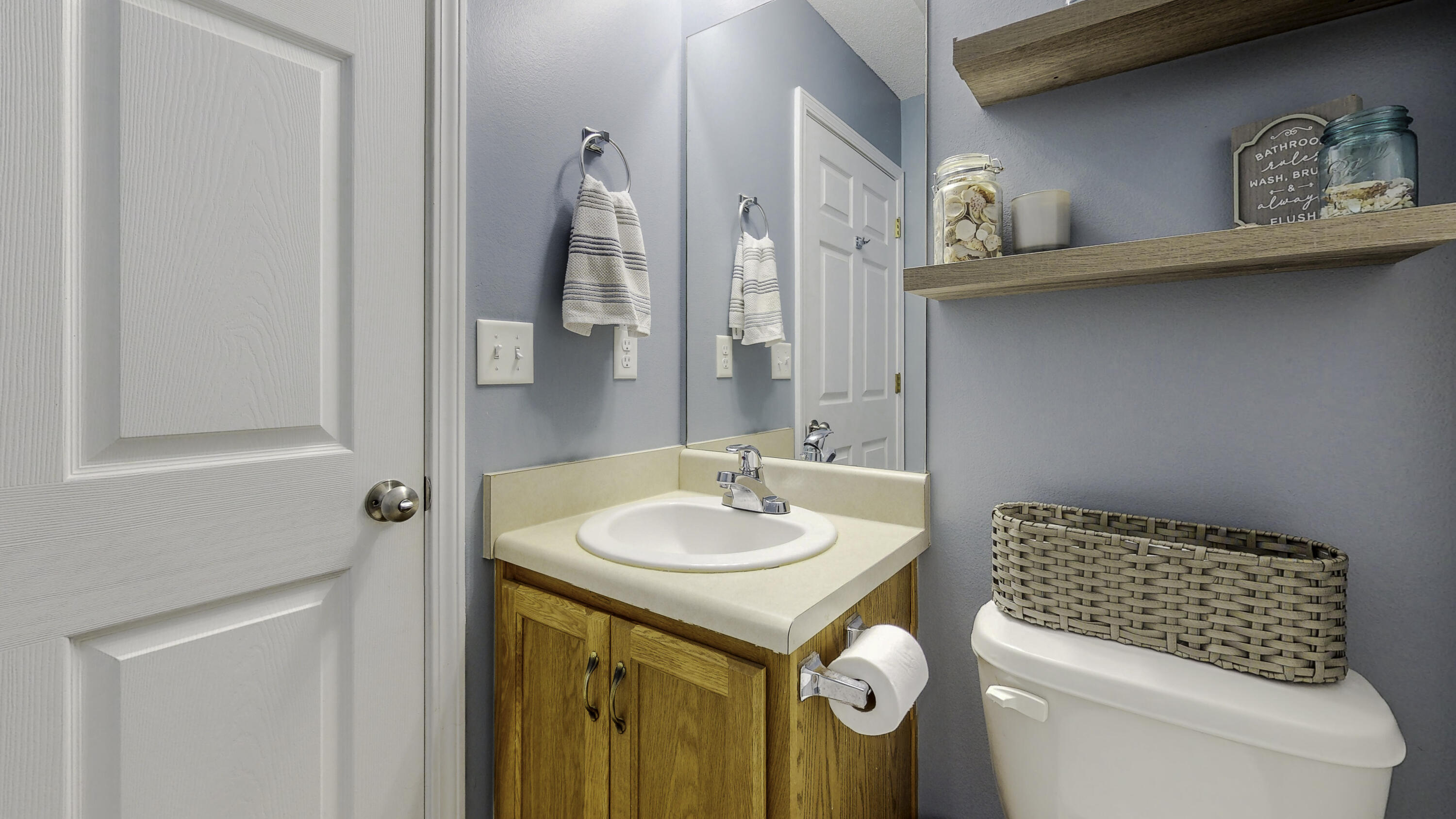 4696 Bobolink Way Crestview, FL 32539 - Photo 19 of 21 a bathroom with a sink and a mirror