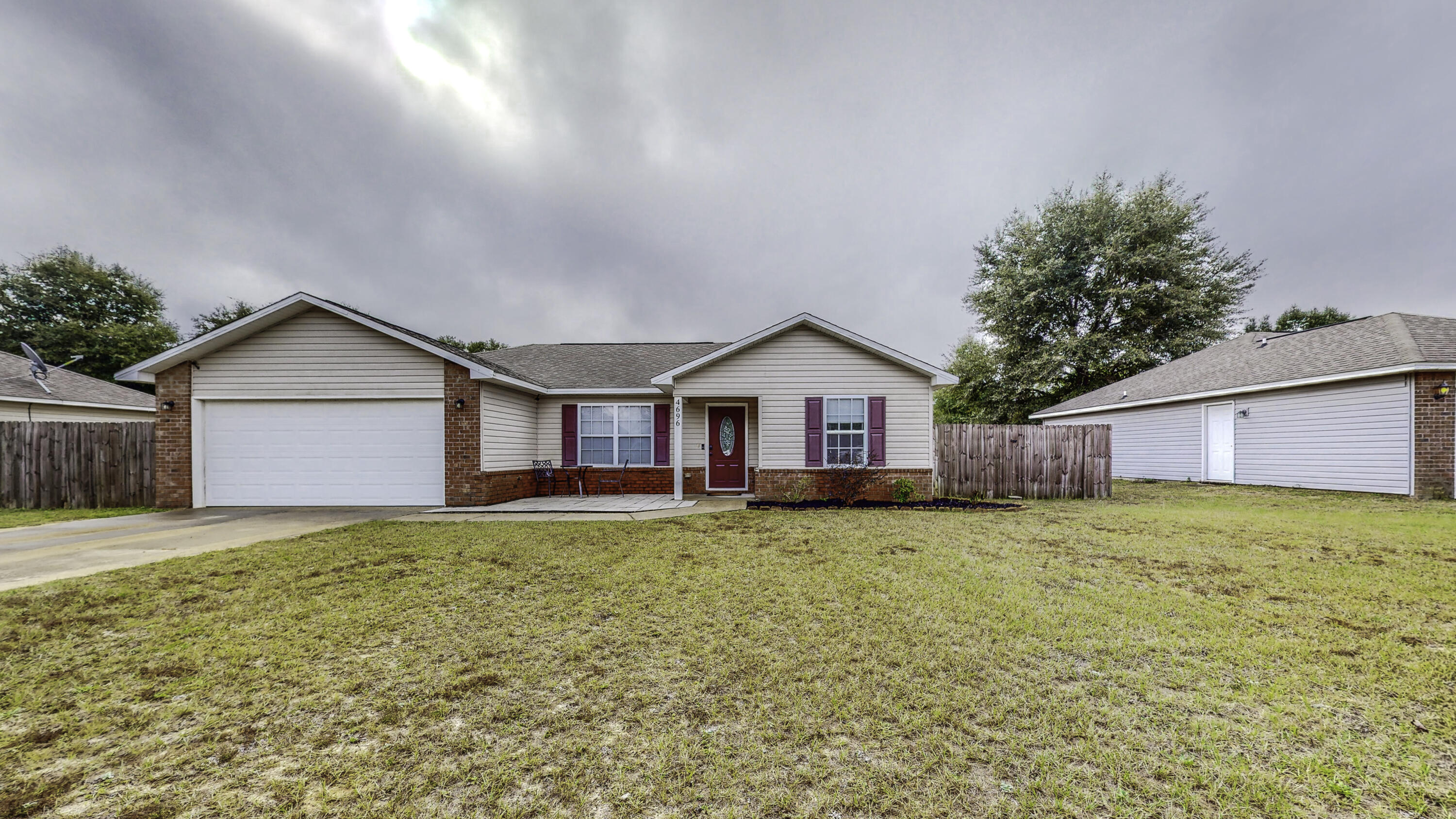 4696 Bobolink Way Crestview, FL 32539 - Photo 2 of 21 a front view of house with yard and garage