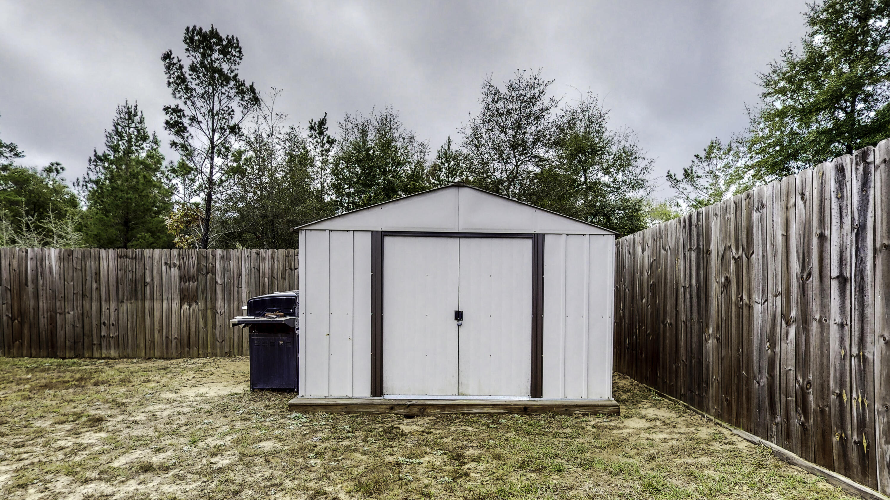 4696 Bobolink Way Crestview, FL 32539 - Photo 21 of 21 a view of backyard of house with wooden fence
