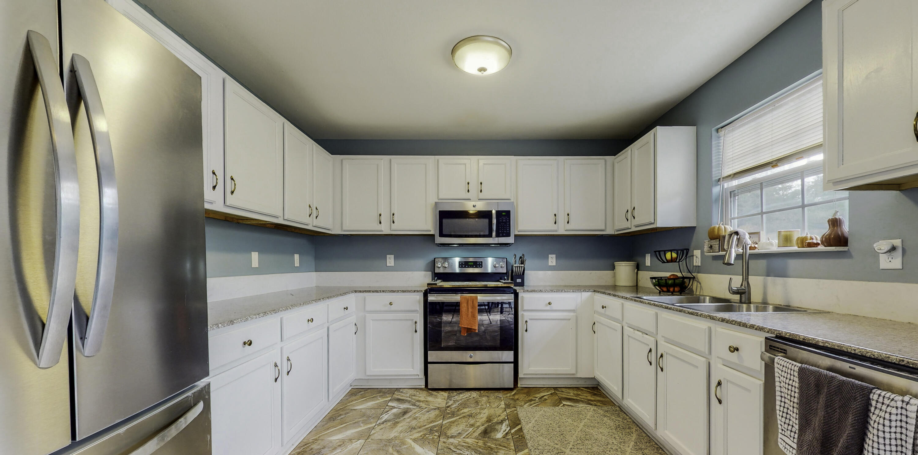 4696 Bobolink Way Crestview, FL 32539 - Photo 4 of 21 a kitchen with stainless steel appliances granite countertop a refrigerator sink and cabinets