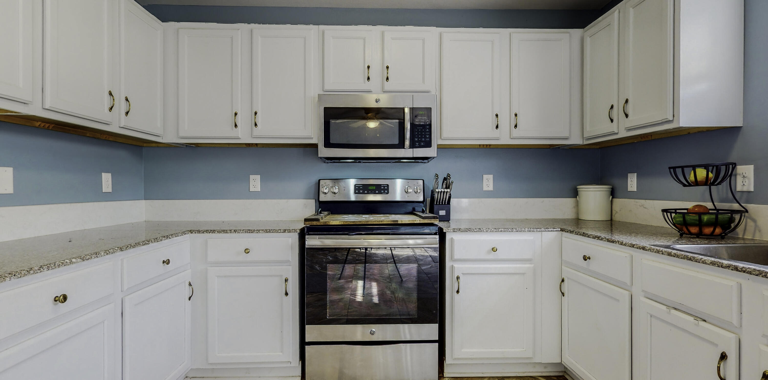 4696 Bobolink Way Crestview, FL 32539 - Photo 5 of 21 a kitchen with white cabinets and white appliances