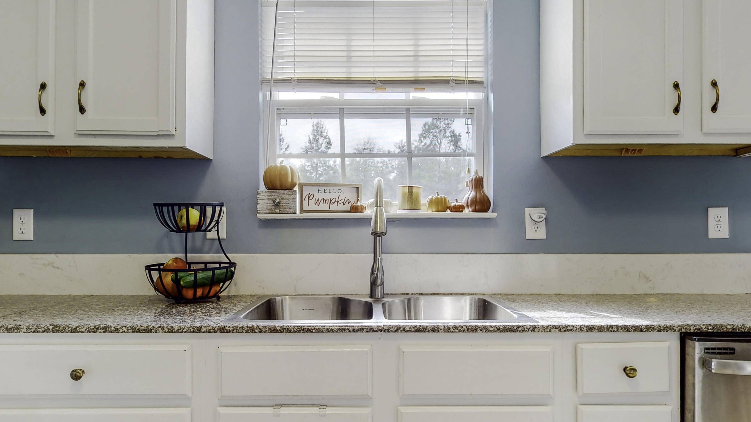 4696 Bobolink Way Crestview, FL 32539 - Photo 7 of 21 a kitchen with granite countertop a stove and a cabinets