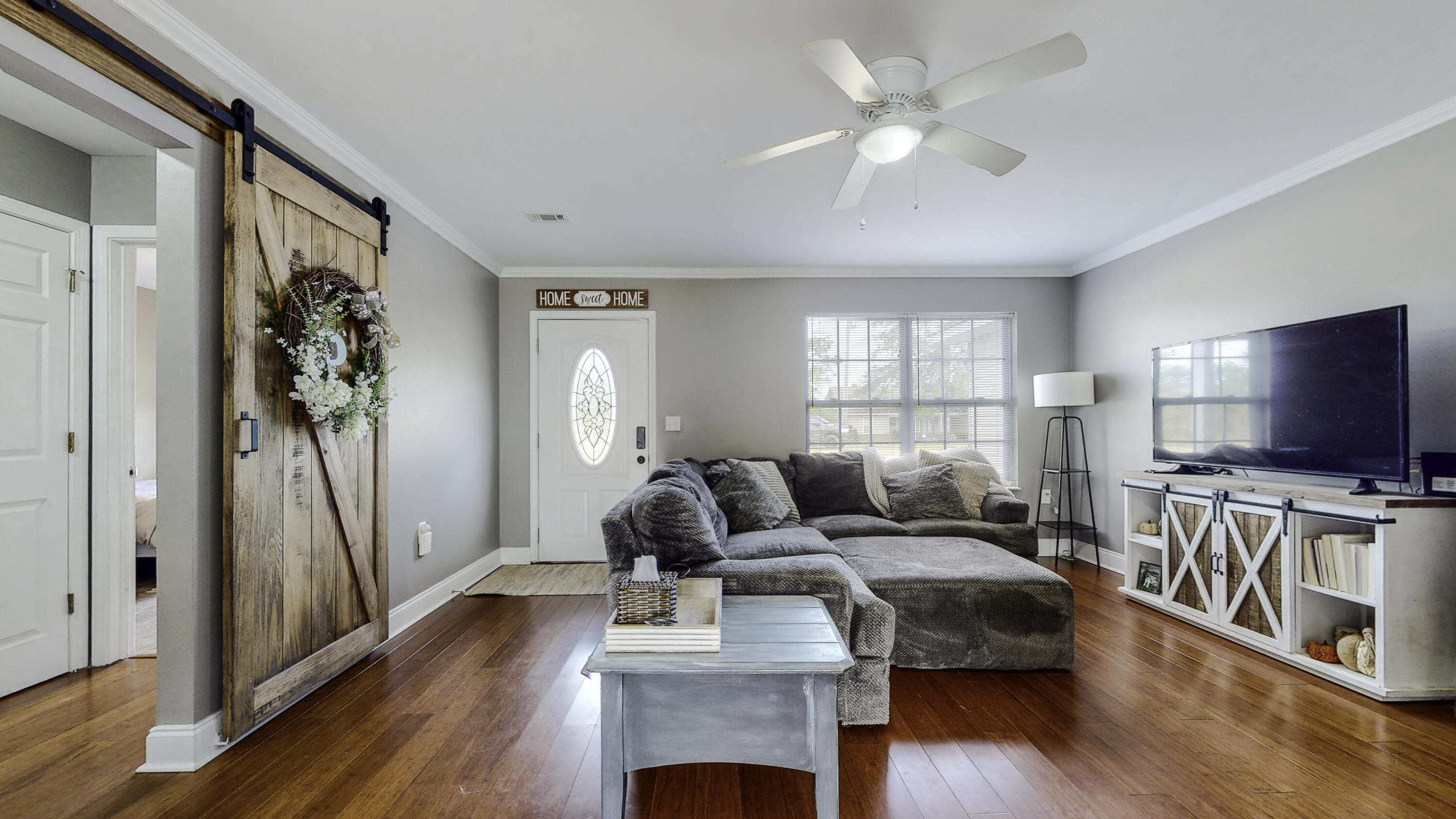 4696 Bobolink Way Crestview, FL 32539 - Photo 10 of 21 a living room with furniture and a flat screen tv