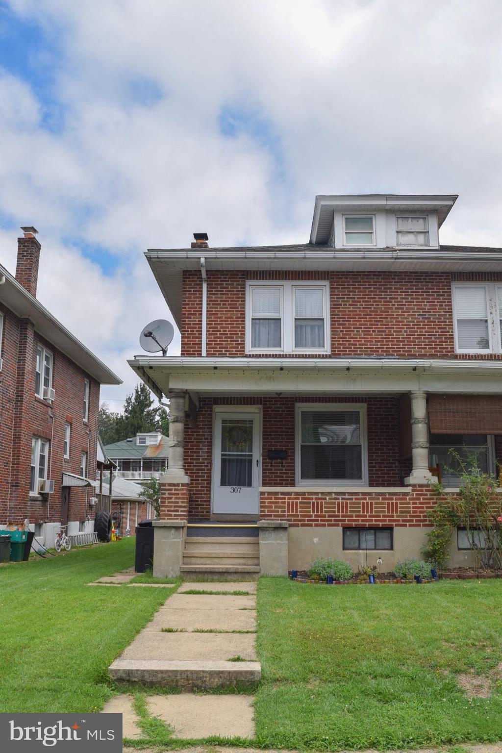Charming brick duplex with inviting porch.