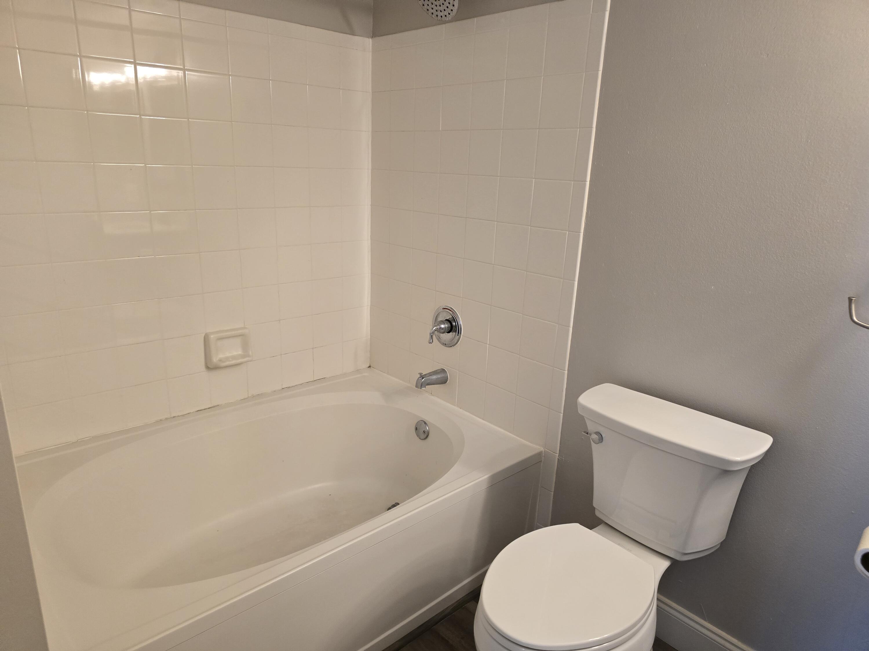 701 Villa Circle Boynton Beach, FL 33435 - Photo 9 of 17 a white toilet and tub sitting next to a bathroom sink