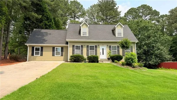 a front view of a house with a yard