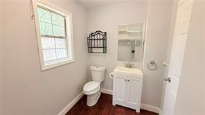 446 Russell Cemetery Road Winder, GA 30680 - Photo 16 of 40 a white toilet sitting next to a bathroom sink