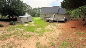446 Russell Cemetery Road Winder, GA 30680 - Photo 28 of 40 a house view with a sitting space and garden