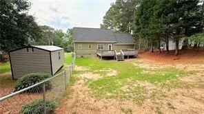 a view of a house with a yard balcony and sitting area