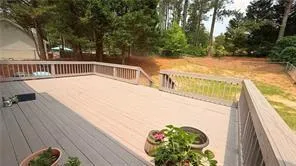 a view of a swimming pool with a patio and a yard