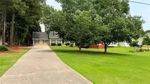 a view of a house with a backyard