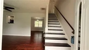 a view of entryway and hall with wooden floor