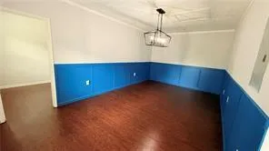 a view of empty room with wooden floor and ceiling fan