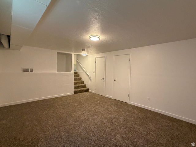 375 East 10560 South Sandy, UT 84070 - Photo 13 of 21 Finished room featuring neutral carpeting, white walls, and a built-in staircase with white railing